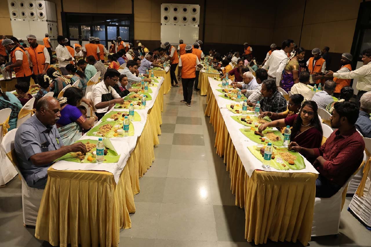 Guests dining on traditional banana leaf veg meal